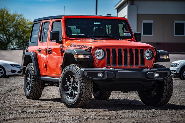 photo-of-red-rubicon-parked-on-dirt-road-2301220
